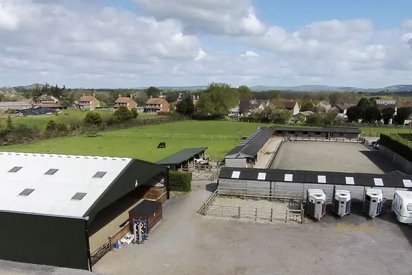 Aerial view of the indoor arena building, outdoor arena and horseboxes