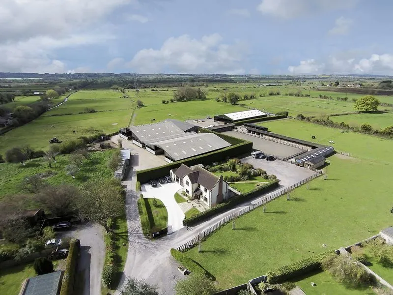 Aerial view of Hill Farm Equestrian, showing the house, stables, indoor arena and surrounding paddocks