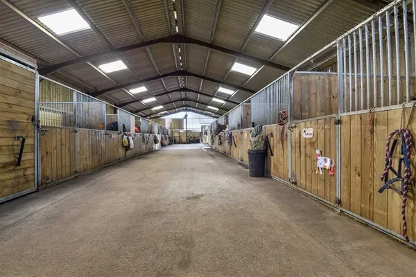 The wide central aisle of the American barn with stables either side